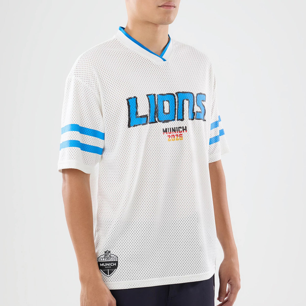 The model is wearing this NFL International Games 2026 Graphic Detroit Lions Mesh Jersey in white. 3