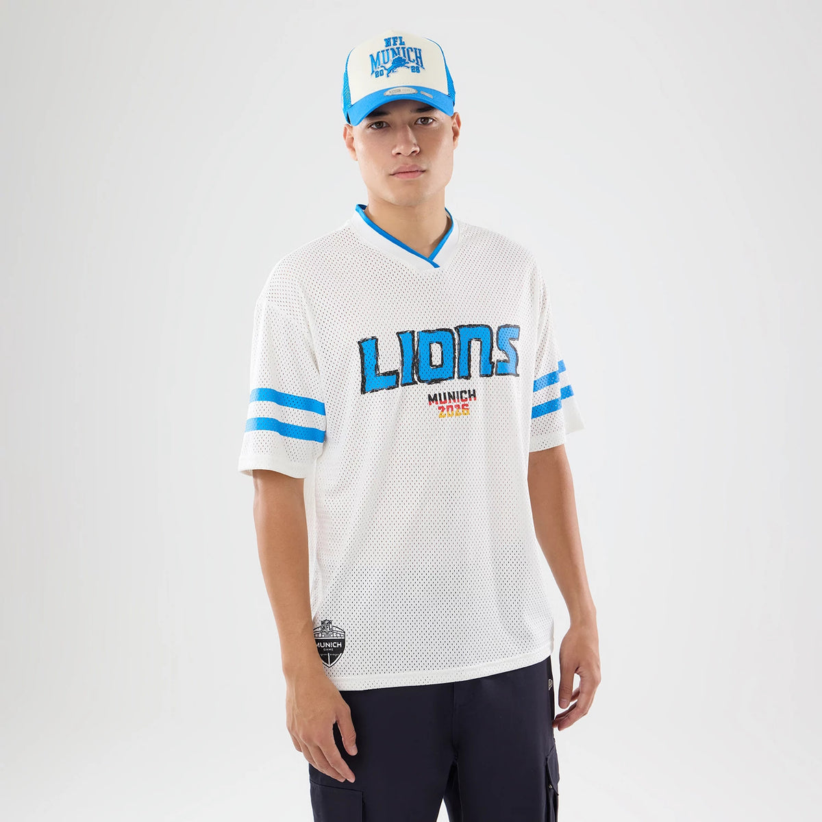 The model is wearing this NFL International Games 2026 Graphic Detroit Lions Mesh Jersey in white. 1