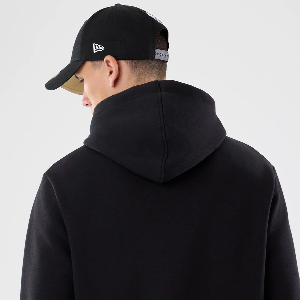 The model is wearing this NFL Patch New Orleans Saints Pullover Hoodie in black. 7