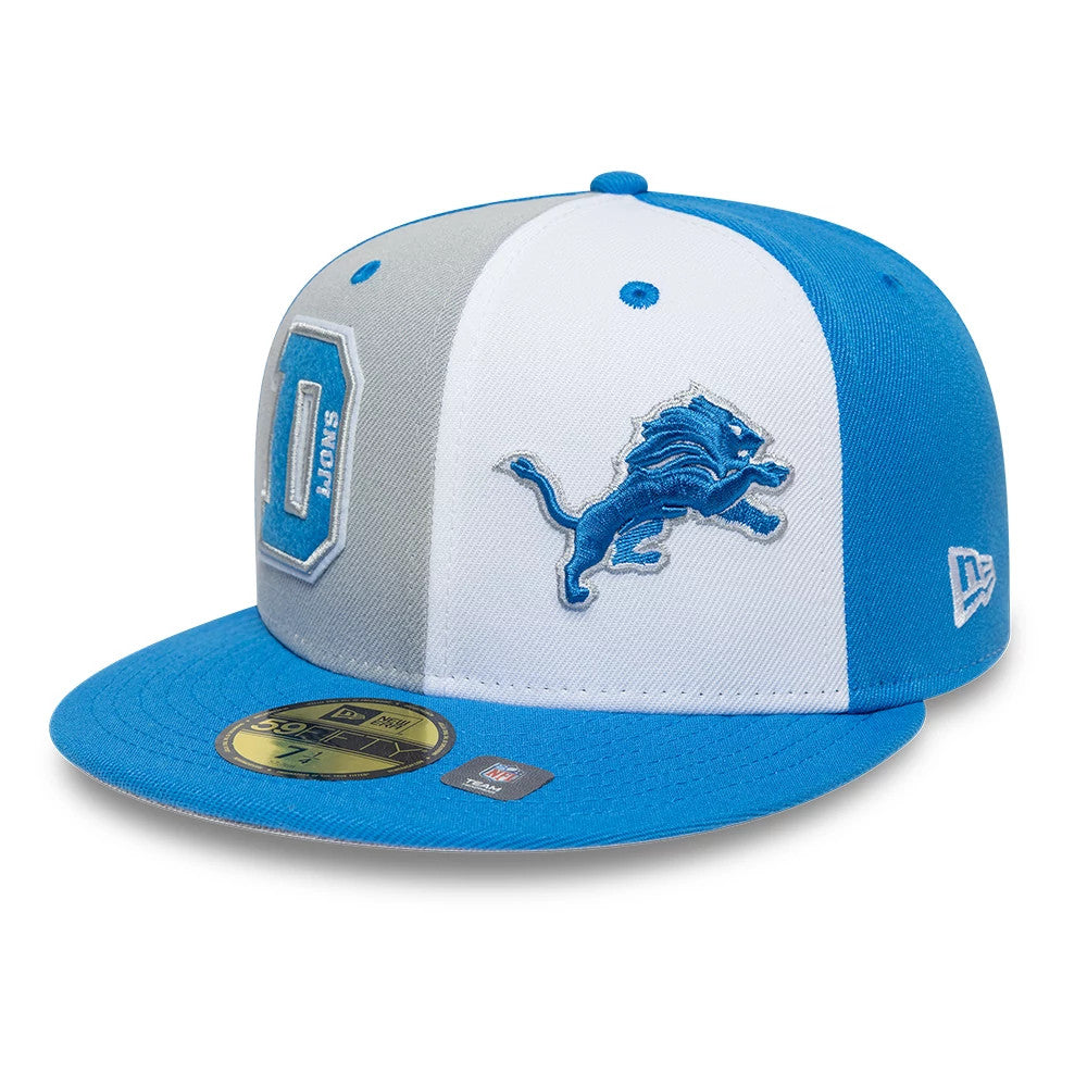Detroit Lions NFL International Games Blue New Era 59FIFTY Fitted Cap, three-quarter view showing the blue embroidered lion logo on the white front panel, a blue and grey colour block design, and a matching blue visor with gold 59FIFTY size sticker.