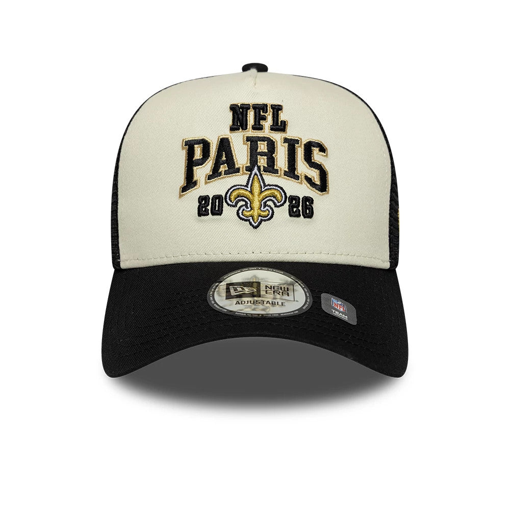 Saints NFL International Games 2026 Paris Black New Era 9FORTY A-Frame Trucker Adjustable Cap, front view showing the black and gold embroidered NFL Paris 2026 text and fleur-de-lis logo on the cream front panel, with a curved black visor.