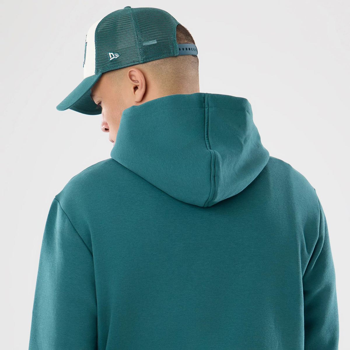 The model is wearing this NFL International Games 2026 Philadelphia Eagles Pullover Hoodie in dark green. 7