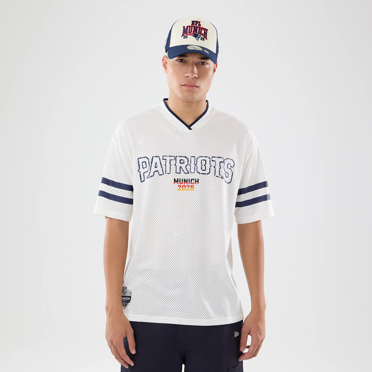 The model is wearing this NFL International Games 2026 New England Patriots Mesh Jersey in white. 1