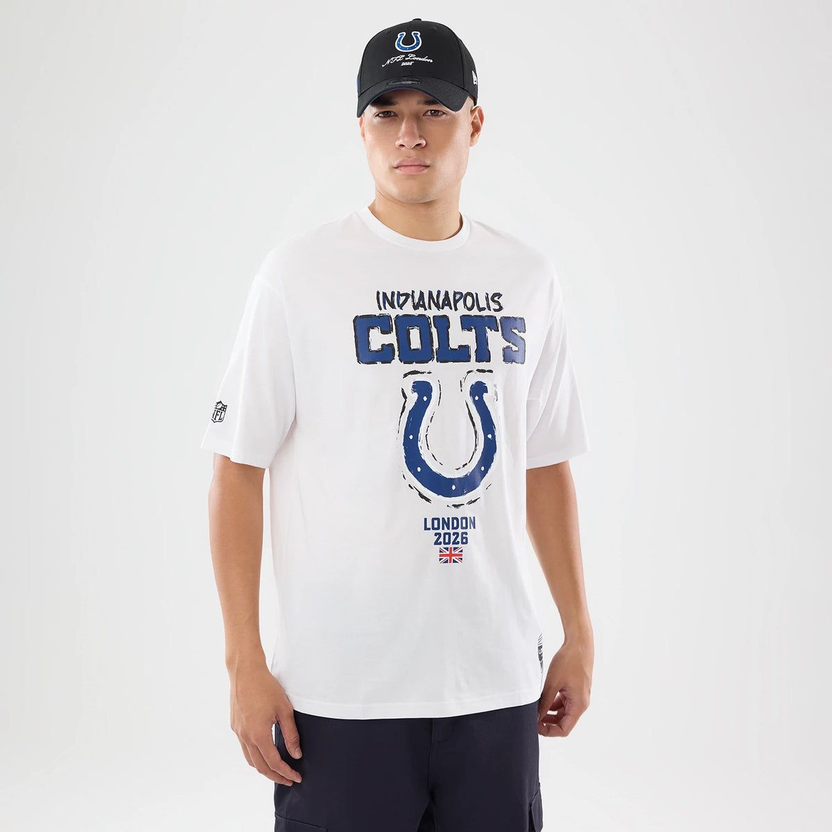 The model is wearing this NFL International Games 2026 Indianapolis Colts Oversized T-Shirt in white. 1