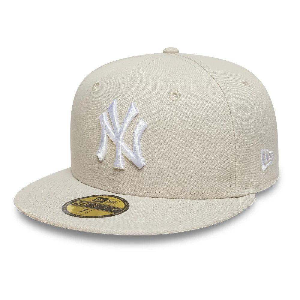 New York Yankees MLB Light Beige New Era 59FIFTY Fitted Cap, three-quarter view showing the raised white embroidered NY logo on the front panels, beige flat visor with a gold 59FIFTY size sticker, and the New Era flag logo on the left side.