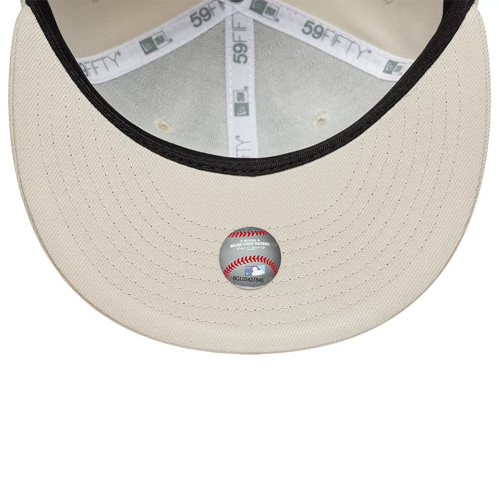 New York Yankees MLB Light Beige New Era 59FIFTY Fitted Cap, inside view showing the white 59FIFTY taping along the seams, a black sweatband, and a transparent MLB sticker on the light beige undervisor.