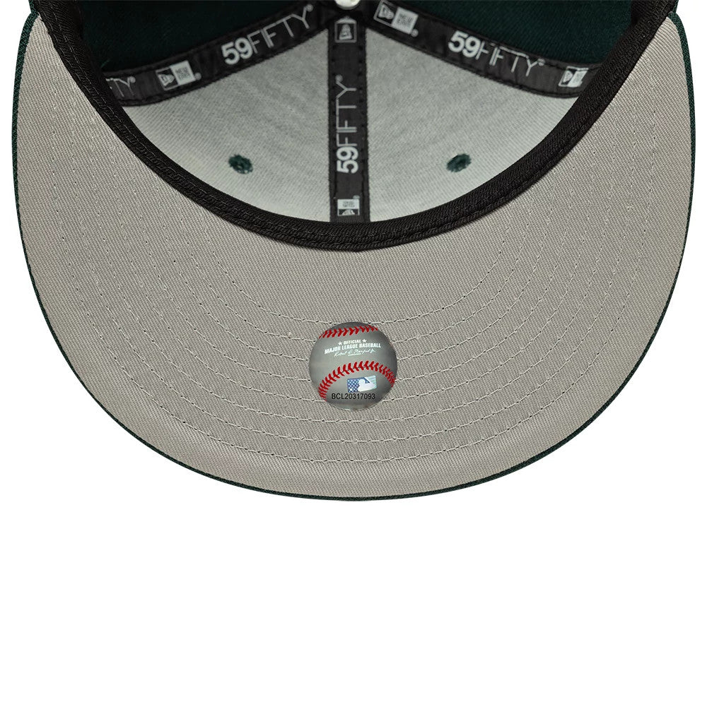 Chicago White Sox MLB Core Dark Green New Era 59FIFTY Fitted Cap, inside view showing grey taping with 59FIFTY branding, a light grey undervisor, and a round silver sticker with a baseball graphic centrally placed on the visor.