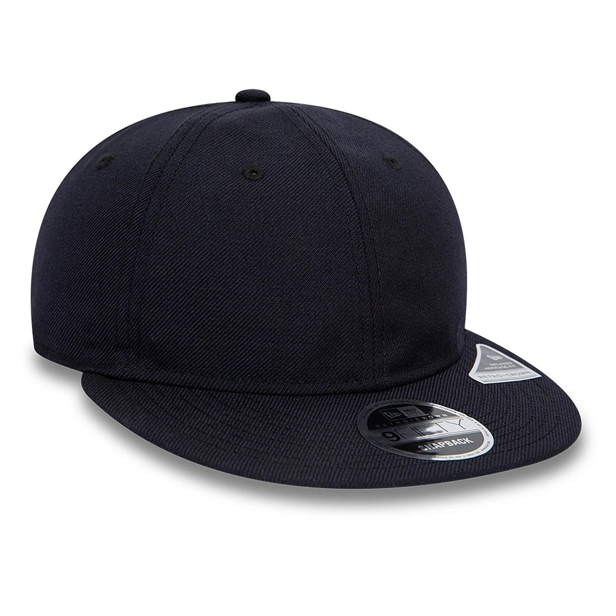 Blank New Era Navy Retro Crown 9FIFTY Snapback Cap, three-quarter view showing a flat navy visor with a black and silver 9FIFTY size sticker, embroidered navy eyelets on the structured crown, and a New Era flag logo on the left side.