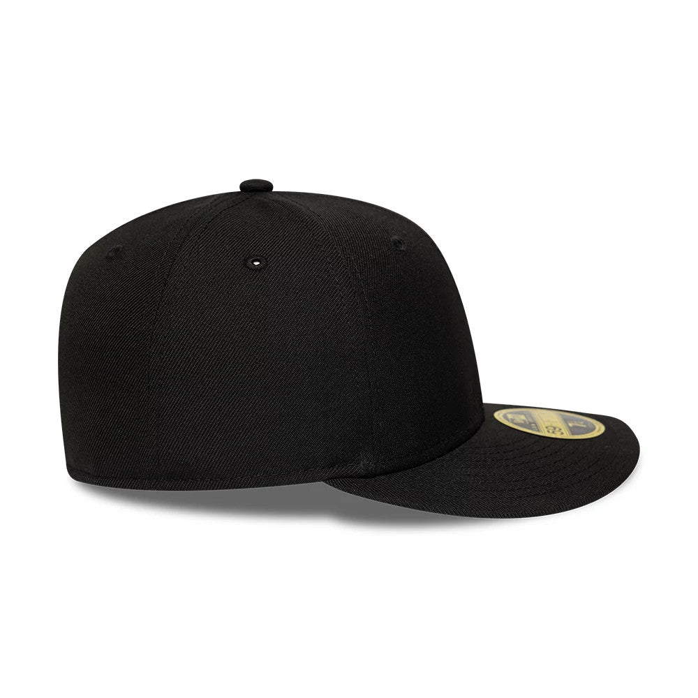 New Era Core Black Low Profile 59FIFTY Fitted Cap, side view showing the black crown with matching eyelets and top button, a slightly curved black visor, and the gold 59FIFTY size sticker on the upper side of the visor.