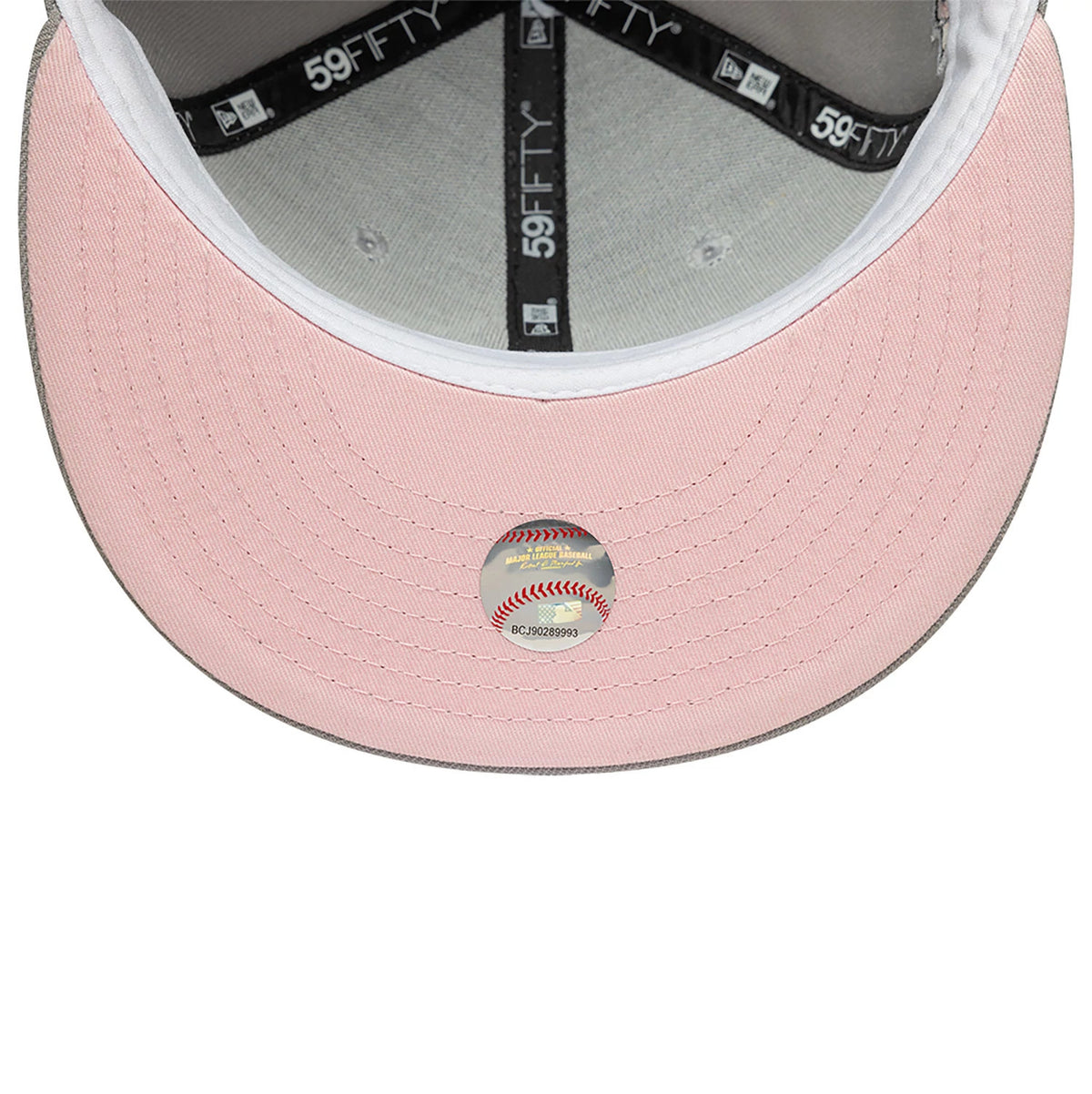New York Yankees Essential Pack Sidepatch Grey New Era 59FIFTY Fitted Cap, inside view showing the light pink undervisor, dark grey crown taping with repeated 59FIFTY branding, and the cap size sticker placed centrally on the undervisor.