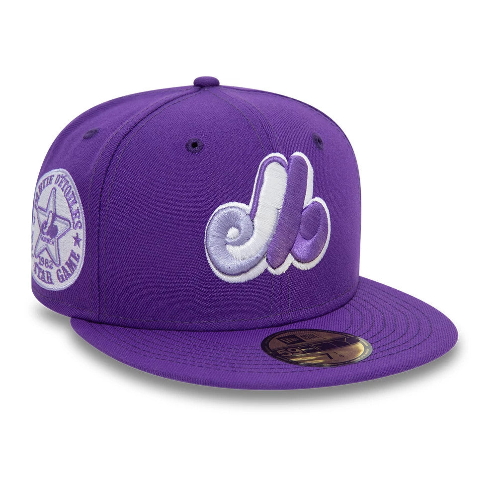 Montreal Expos All Star Game Purple New Era 59FIFTY Fitted Cap, front view showing the raised white and lavender embroidered logo on the front panels, purple flat visor, and gold 59FIFTY size sticker on the visor.