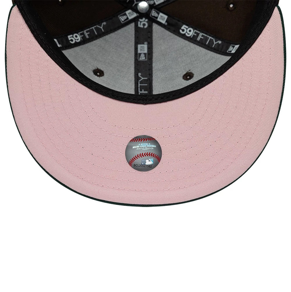 Astros MLB Cooperstown Dark Brown & Dark Green New Era 59FIFTY Fitted Cap, inside view showing the pink undervisor with a Major League Baseball holographic authenticity sticker in the centre, black sweatband and dark brown panel taping.
