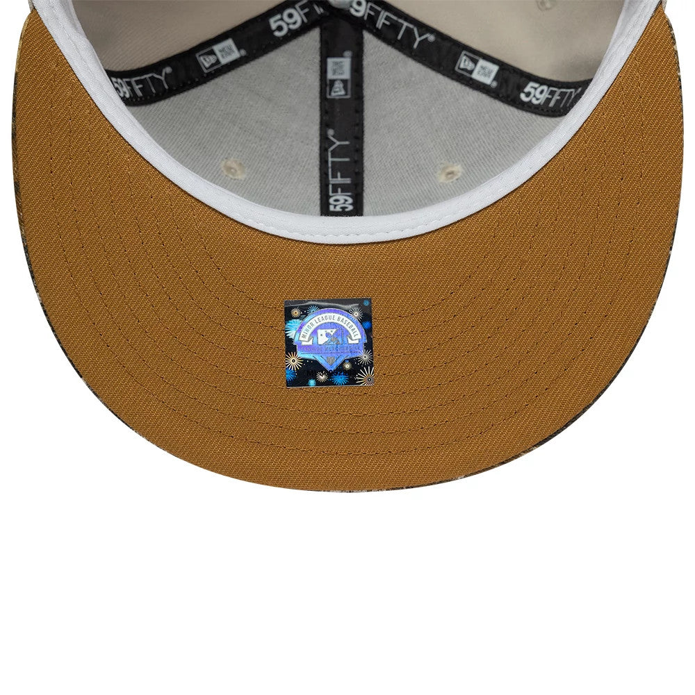 Gwinnett Stripers MiLB Hometown Beige New Era 59FIFTY Fitted Cap, inside view showing a black 59FIFTY taping across the seams, a light grey sweatband lining the inner edge, and a small holographic sticker on the underside of the brown visor.