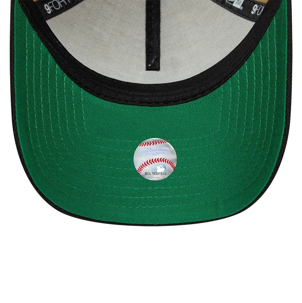 Athletics MLB Vegas Gold New Era 9FORTY A-Frame Cap, inside view showing the black taping along the seams, grey sweatband, and green undervisor with a small holographic sticker featuring a baseball graphic, lending authenticity to the design.