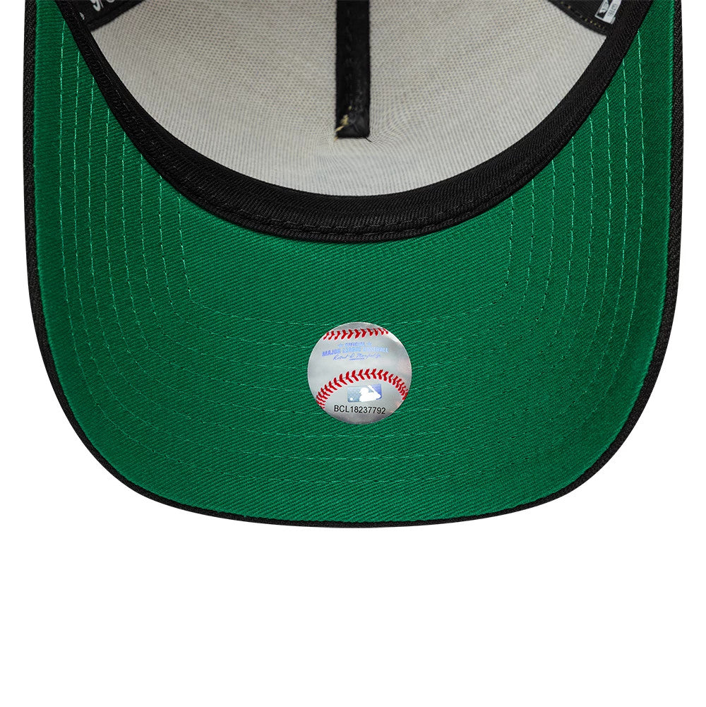 Chicago White Sox MLB Vegas Gold New Era 9FORTY A-Frame Cap, inside view showing a green undervisor, contrasting black sweatband with white taping, and a round MLB authentication sticker placed on the centre of the visor.