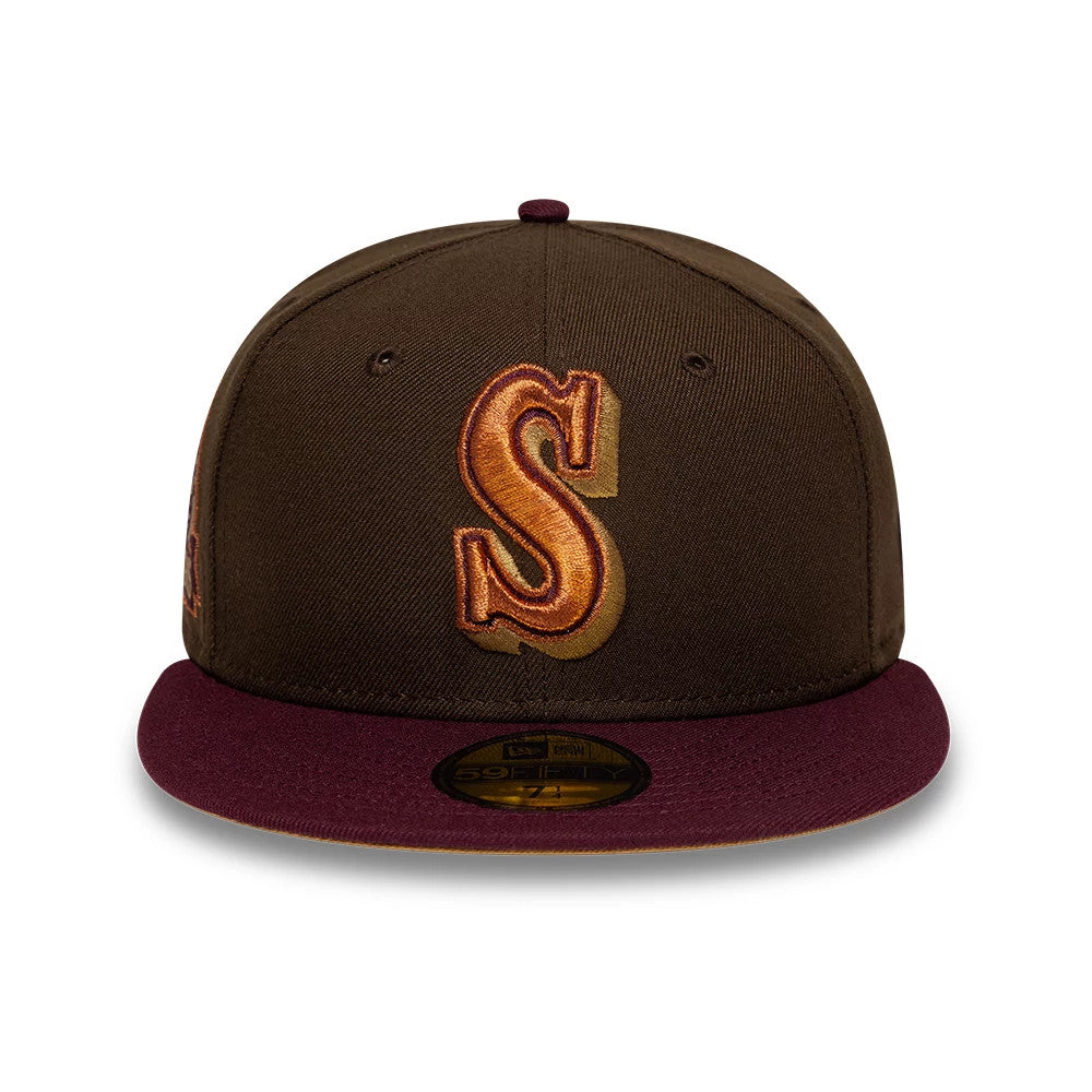 Seattle Mariners MLB Cooperstown Dark Brown New Era 59FIFTY Fitted Cap, front view showing a large, raised brown and orange embroidered S logo on the dark brown crown, with a burgundy visor and a gold 59FIFTY size sticker on the visor.