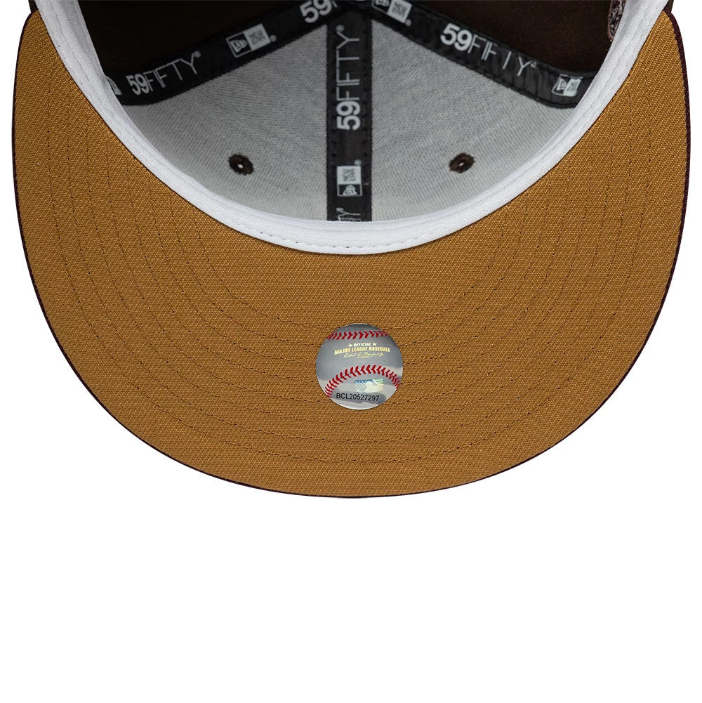 Seattle Mariners MLB Cooperstown Dark Brown New Era 59FIFTY Fitted Cap, inside view showing a brown undervisor with a reflective authenticity sticker, black 59FIFTY taping around the white interior, and brown eyelets on the white panels.