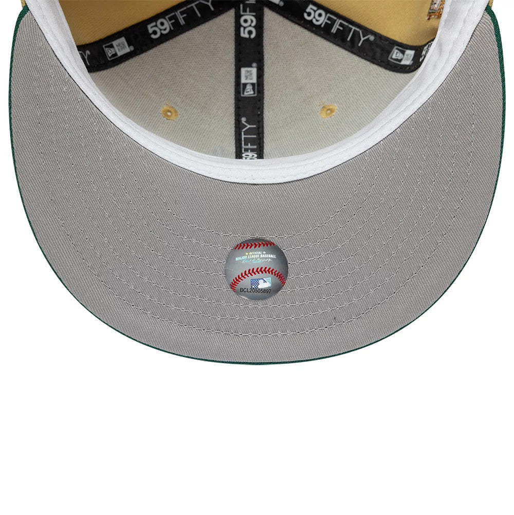 Seattle Mariners MLB Vegas Gold New Era 59FIFTY Fitted Cap, inside view showing the grey undervisor with an MLB holographic sticker, black 59FIFTY taping along the seams, and a white sweatband encircling the crown interior.