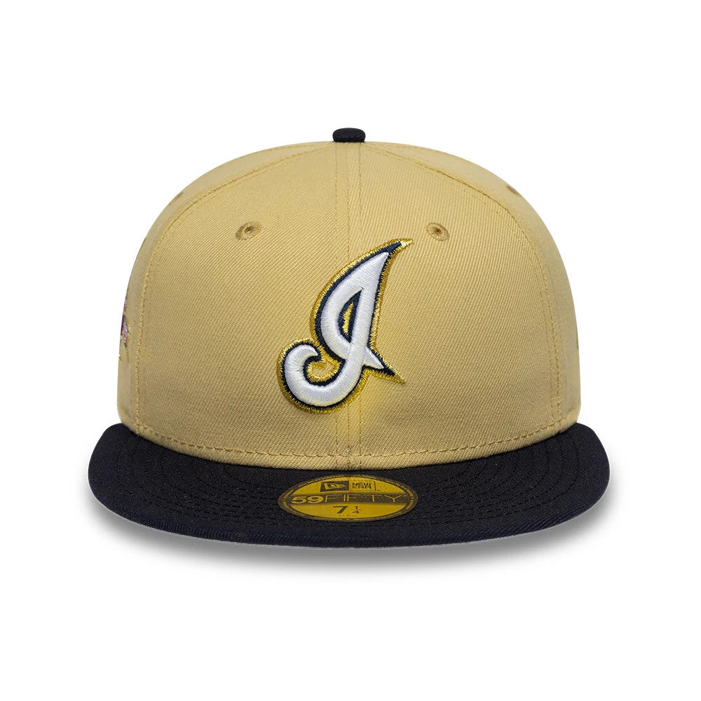 Cleveland Indians MLB Vegas Gold New Era 59FIFTY Fitted Cap, front view showing a white and yellow embroidered script I logo on the front panel, black flat visor with a gold 59FIFTY size sticker, and black top button.