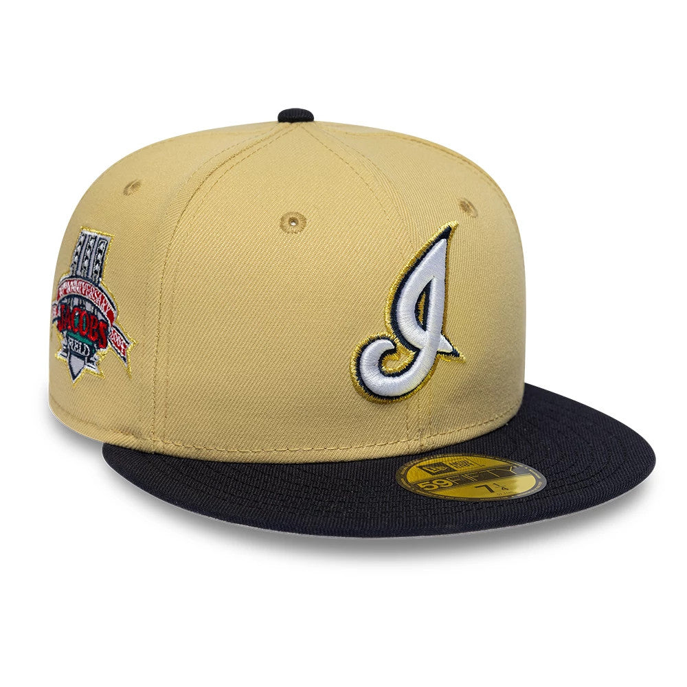 Cleveland Indians MLB Vegas Gold New Era 59FIFTY Fitted Cap, three-quarter view showing the white and gold embroidered C logo on the front panel, a light brown structured crown, and a black flat visor with a gold 59FIFTY size sticker.
