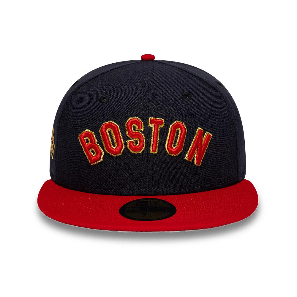 Boston Red Sox MLB Cooperstown Navy New Era 59FIFTY Fitted Cap, front view showing the raised Boston lettering in red and yellow embroidery on the structured navy crown, with a contrasting red flat visor and a gold 59FIFTY size sticker.