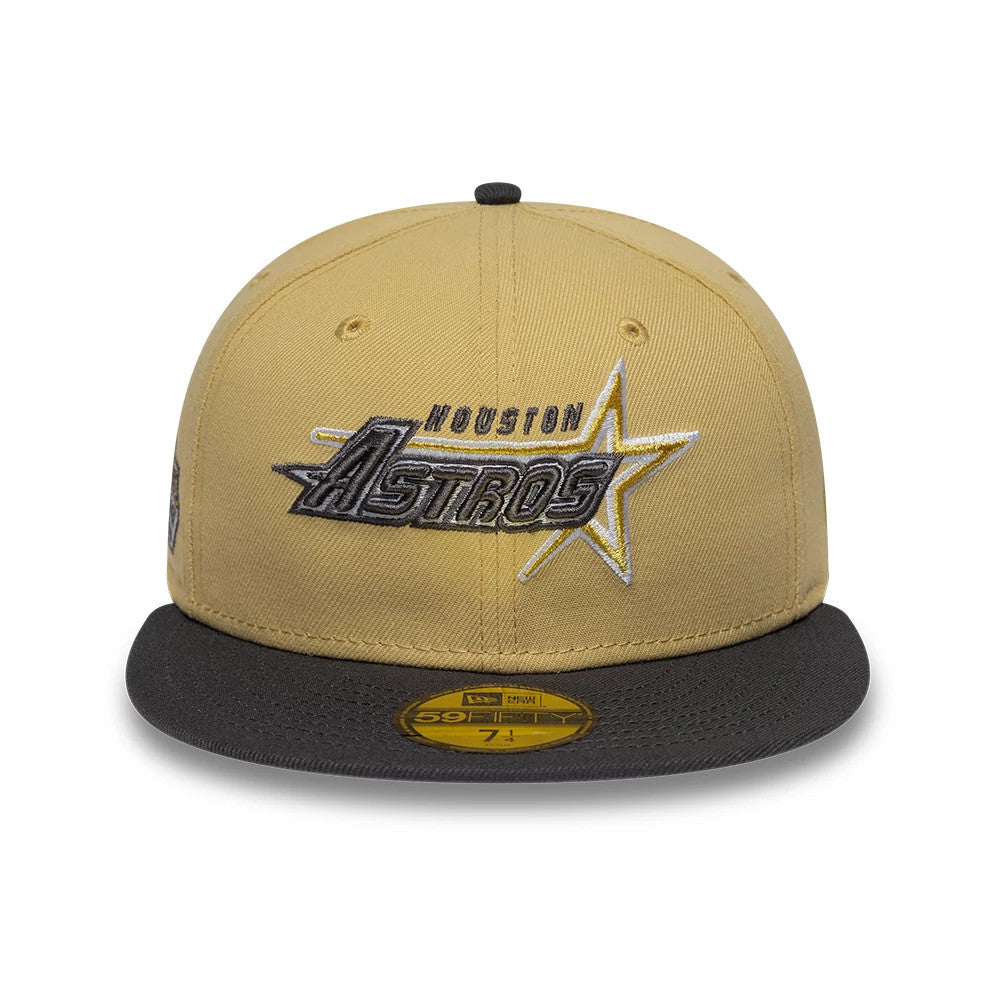 Houston Astros MLB Vegas Gold New Era 59FIFTY Fitted Cap, front view showing the team's logo with raised embroidery in grey and white on the vegas gold crown, complemented by a black flat visor and a gold 59FIFTY size sticker on it.