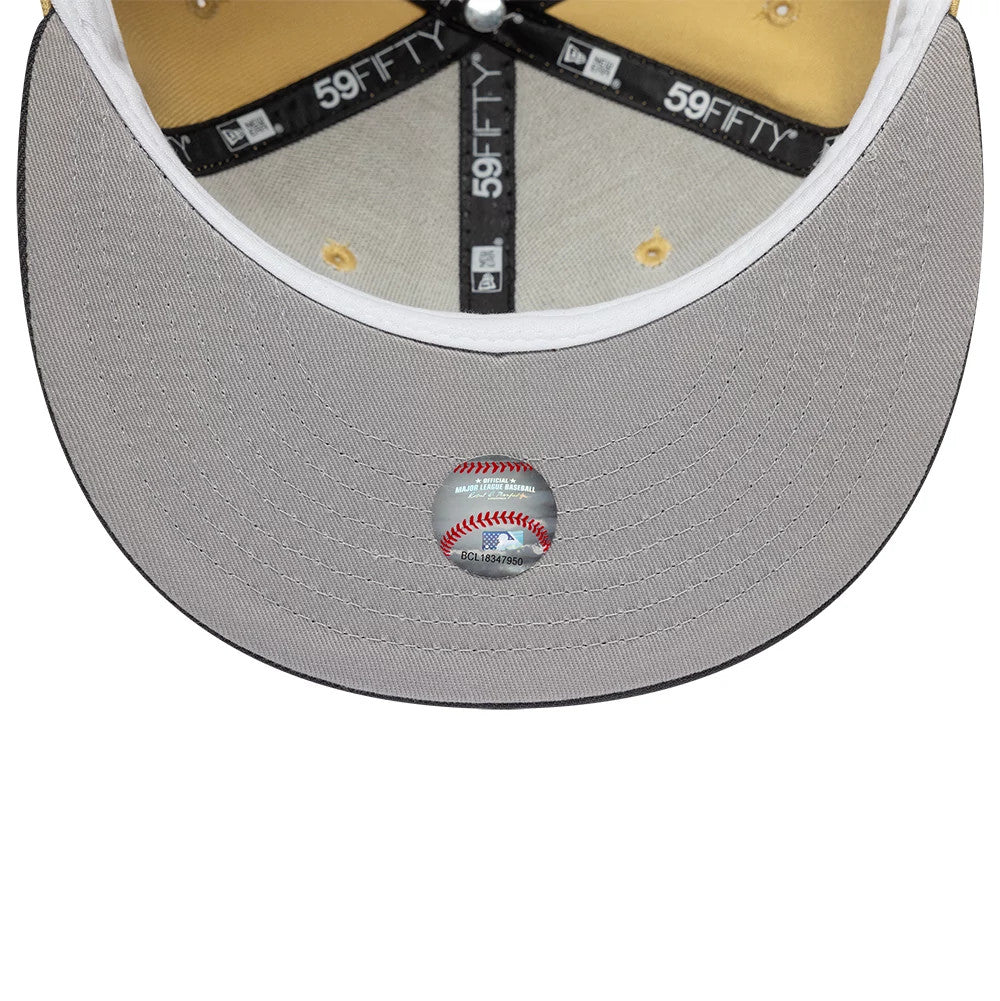 Houston Astros MLB Vegas Gold New Era 59FIFTY Fitted Cap, inside view showing gold taping with 59FIFTY branding, contrasting black panels, a grey undervisor, and a baseball-themed sticker centred on the visor underside.