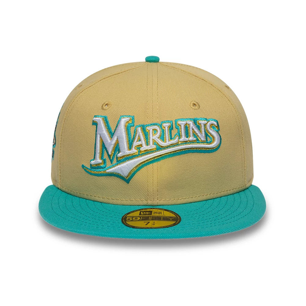 Florida Marlins MLB Vegas Gold & Turquoise New Era 59FIFTY Fitted Cap, front view showing the raised Marlins logo in white and turquoise embroidery on the vegas gold crown, with a turquoise visor and a gold 59FIFTY size sticker on the visor.