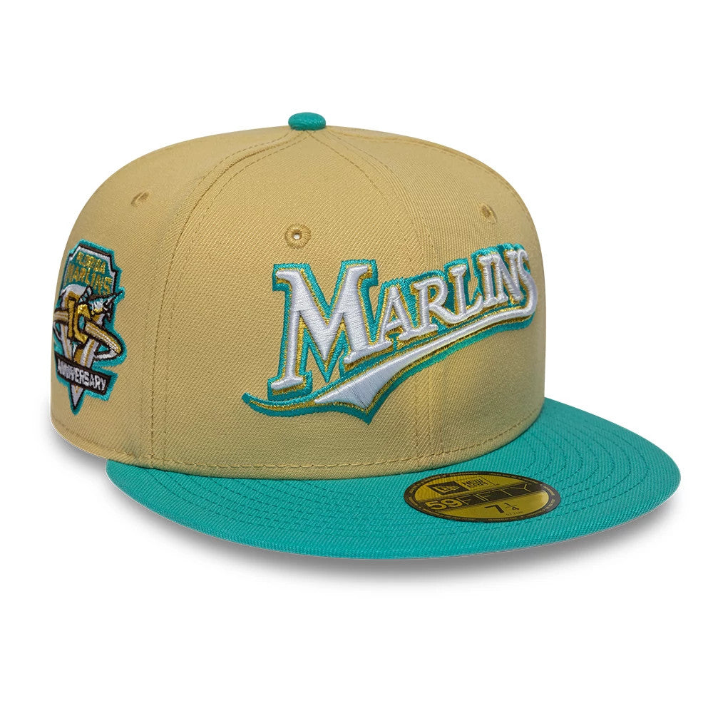 Florida Marlins MLB Vegas Gold & Turquoise New Era 59FIFTY Fitted Cap, three-quarter view showing the raised embroidered Marlins script logo in white and turquoise on the front panel, turquoise flat visor and the gold 59FIFTY size sticker.