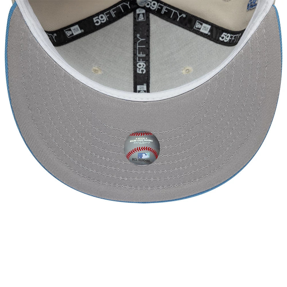 Houston Astros MLB Cooperstown Beige & Blue New Era 59FIFTY Fitted Cap, inside view showing the grey undervisor with a baseball-themed sticker, black taping with white 59FIFTY branding, and a white sweatband encircling the crown.