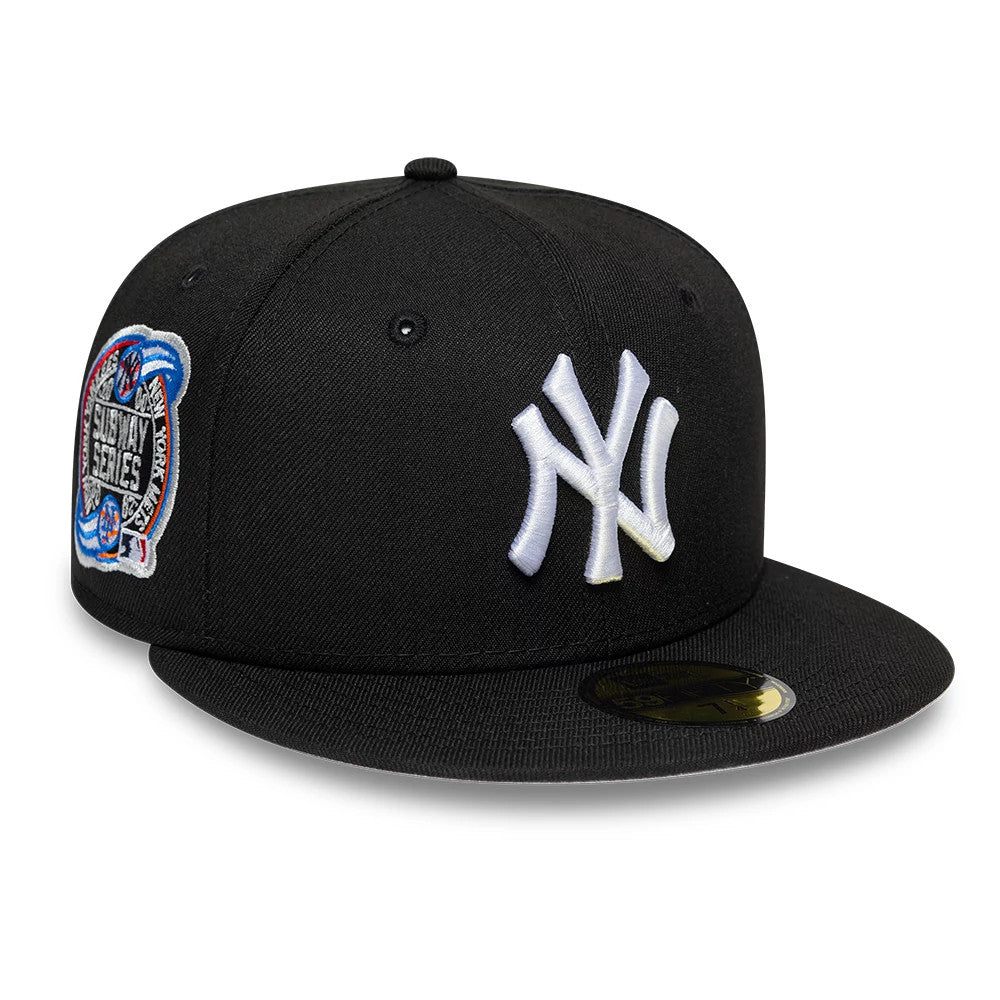 New York Yankees MLB Cooperstown Black New Era 59FIFTY Fitted Cap, three-quarter view showing the raised white NY logo on the front panel, a colourful Subway Series patch on the side, and a gold 59FIFTY size sticker on the flat black visor.