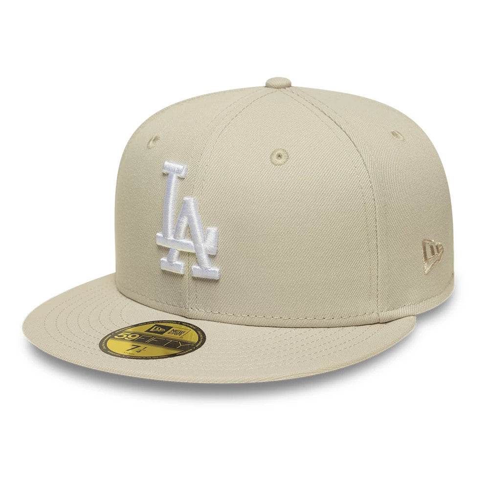 LA Dodgers MLB Beige New Era 59FIFTY Fitted Cap, three-quarter view showing the white LA logo in raised embroidery on the front panel, with a beige flat visor featuring a gold 59FIFTY size sticker and New Era flag logo on the left side.