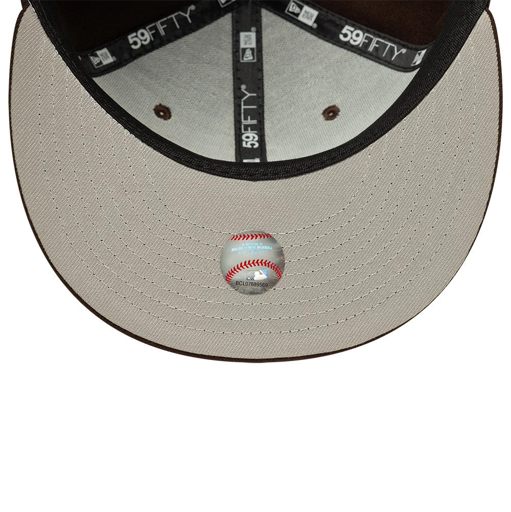 Chicago White Sox MLB Dark Brown New Era 59FIFTY Fitted Cap, inside view showing the grey undervisor with a baseball-themed sticker, black 59FIFTY taping along the seams, and the contrasting grey sweatband lining the interior.