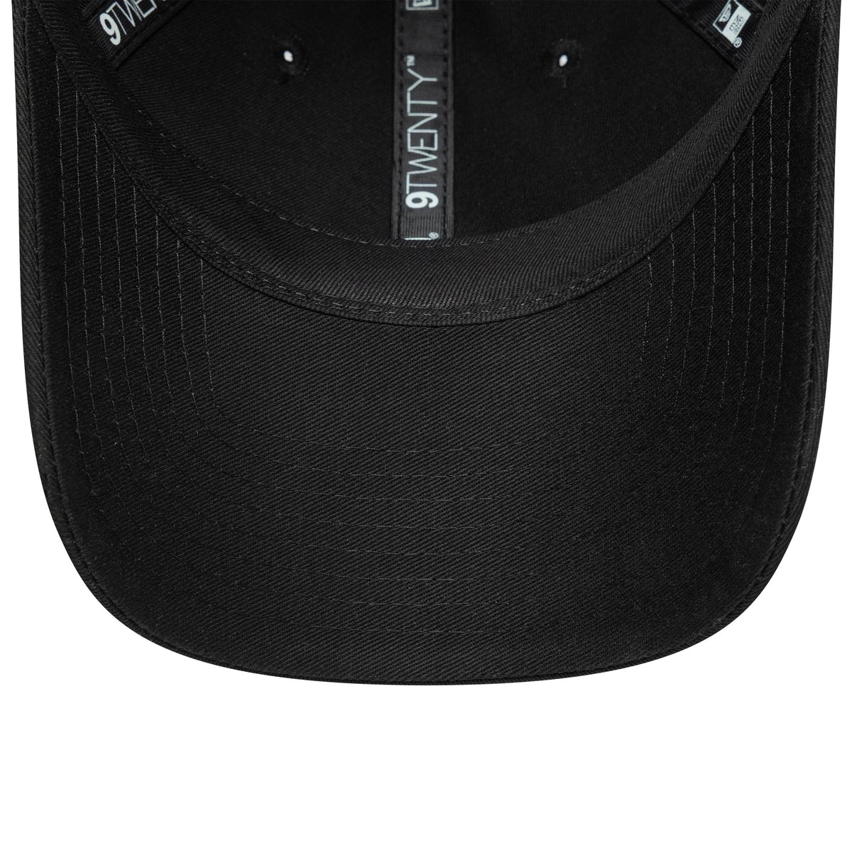 New Era Black 9TWENTY Adjustable Cap, inside view showing the black sweatband and taping printed with 9TWENTY branding, dark undervisor and black stitching across the curved visor.