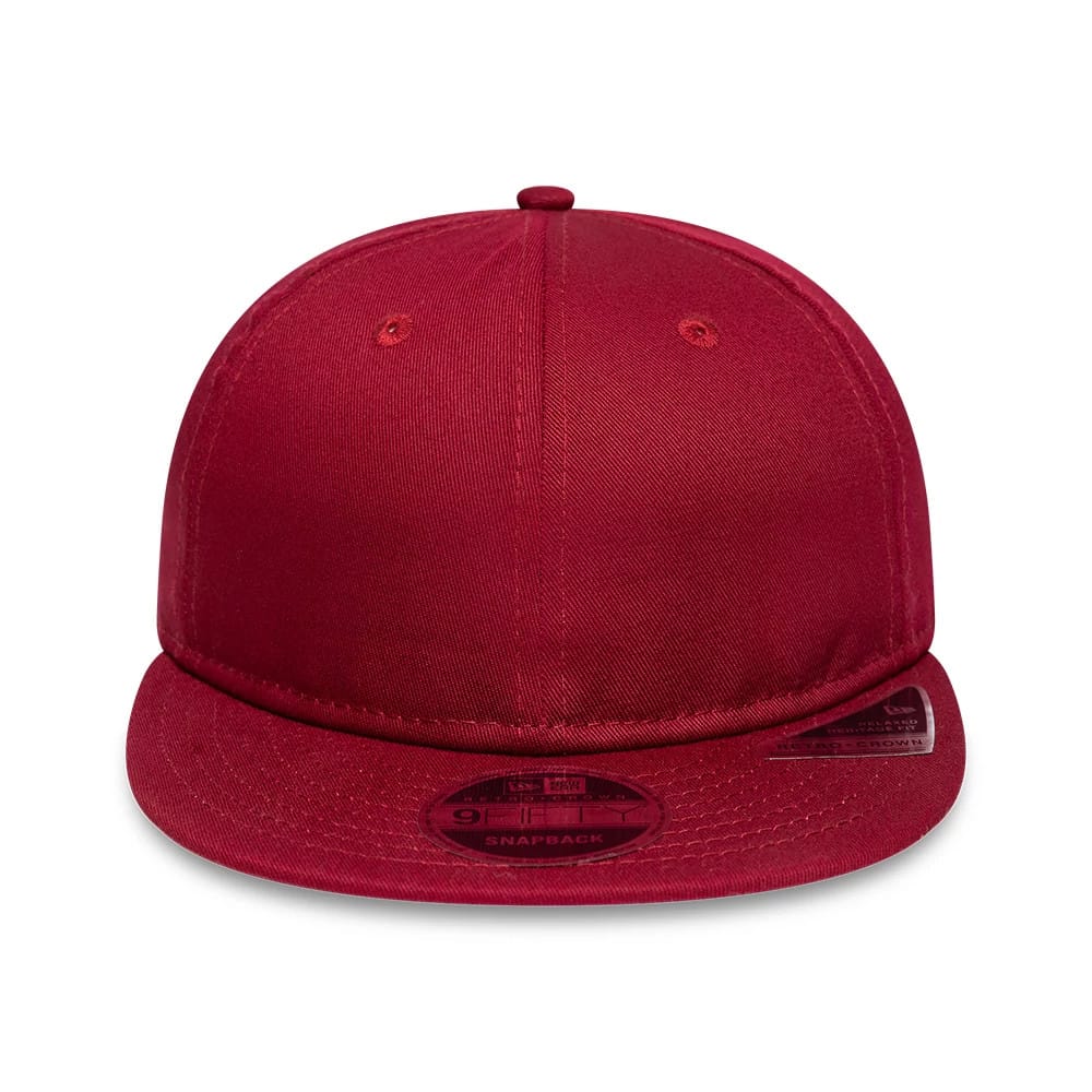 New Era Red Retro Crown 9FIFTY Snapback Adjustable Cap, front view showing the plain red front panel and eyelets, with a slightly curved visor featuring a 9FIFTY size sticker prominently placed at the top.