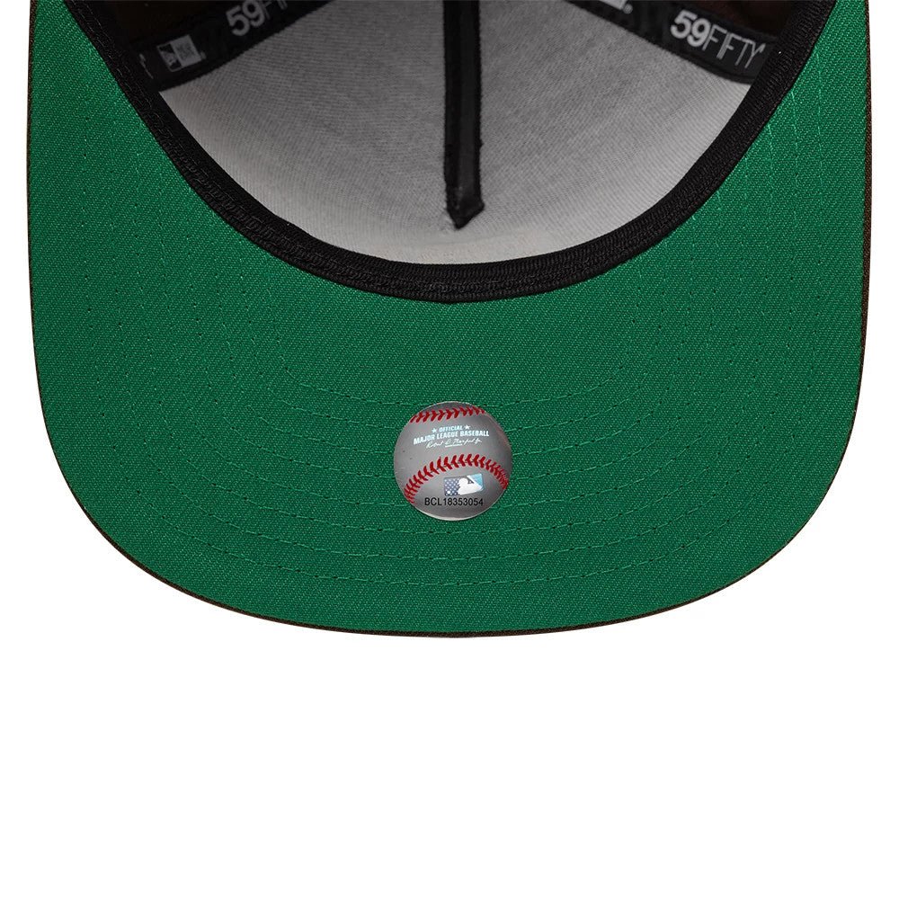 San Diego Padres MLB Dark Brown New Era 59FIFTY A-Frame Fitted Cap, inside view showing the green undervisor with a circular baseball-themed sticker, black taping with white 59FIFTY branding, and a light-coloured sweatband for contrast.