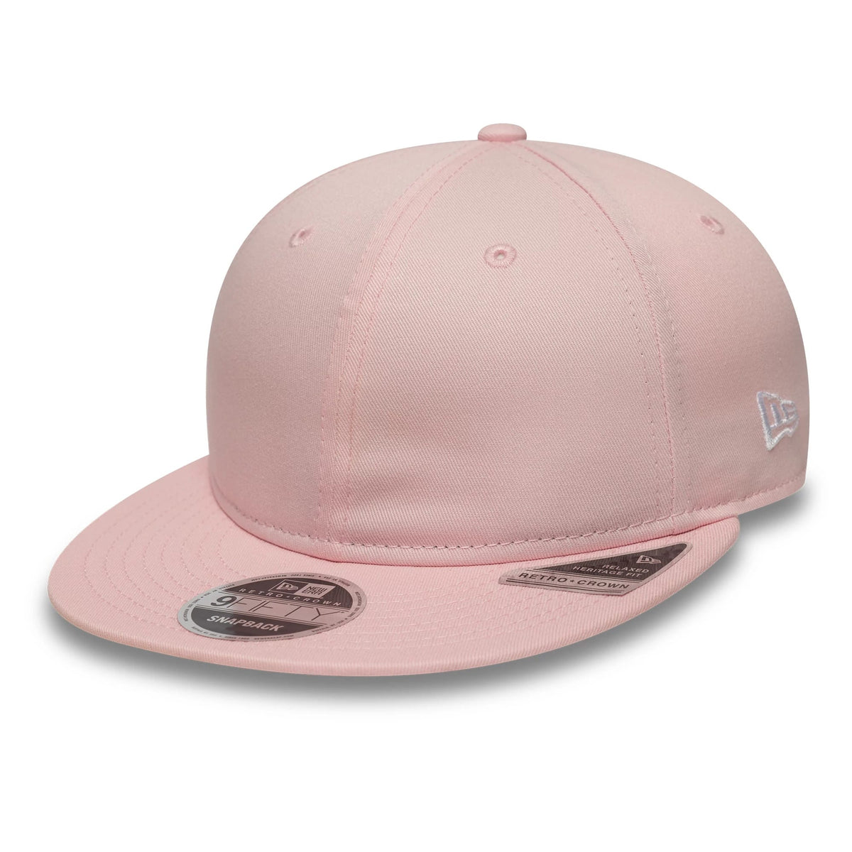 New Era Pink Retro Crown 9FIFTY Snapback Adjustable Cap, three-quarter view showing a light pink structured crown with a curved pink visor, a silver New Era flag logo embroidered on the left side, and a 9FIFTY size sticker on the visor.