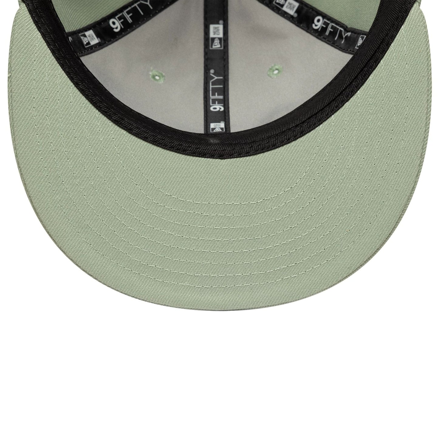 New Era Green Retro Crown 9FIFTY Snapback Adjustable Cap, inside view showing a mint green undervisor with detailed stitching, black taping with white 9FIFTY branding throughout, and green eyelets on the inner panels of the structured crown.