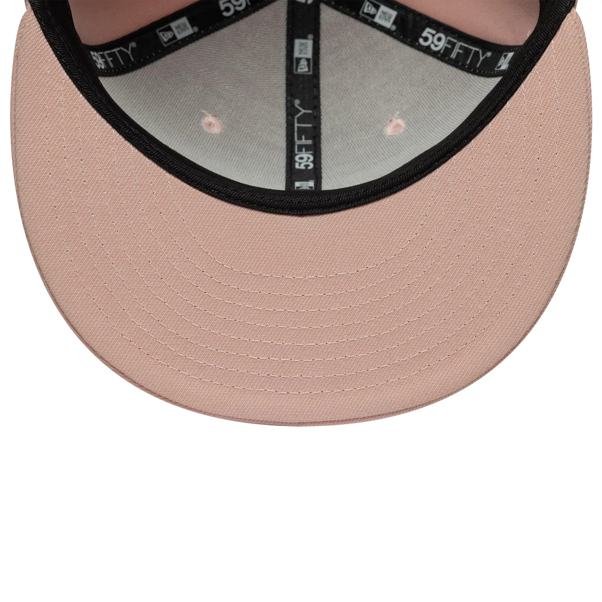New Era Blank Pink 59FIFTY Fitted Cap, inside view showing a black sweatband with 59FIFTY branding, a soft pink undervisor with detailed stitching, and matching pink taping across the panels.