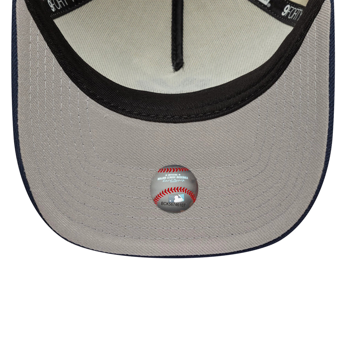 New York Yankees MLB Chrome Blue Contrast Cream New Era 9FORTY A-Frame Adjustable Cap, inside view showing a light cream undervisor with a debossed emblem resembling a baseball, a black sweatband, and black branded taping.