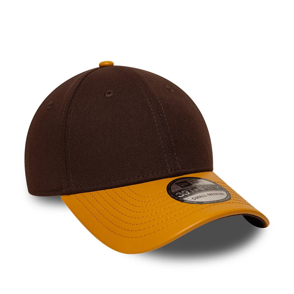 New Era Dark Brown 39THIRTY Stretch Fit Cap, three-quarter view showing a dark brown structured crown with a contrasting mustard yellow curved visor and a 39THIRTY size sticker on the top, with matching yellow top button and eyelets.