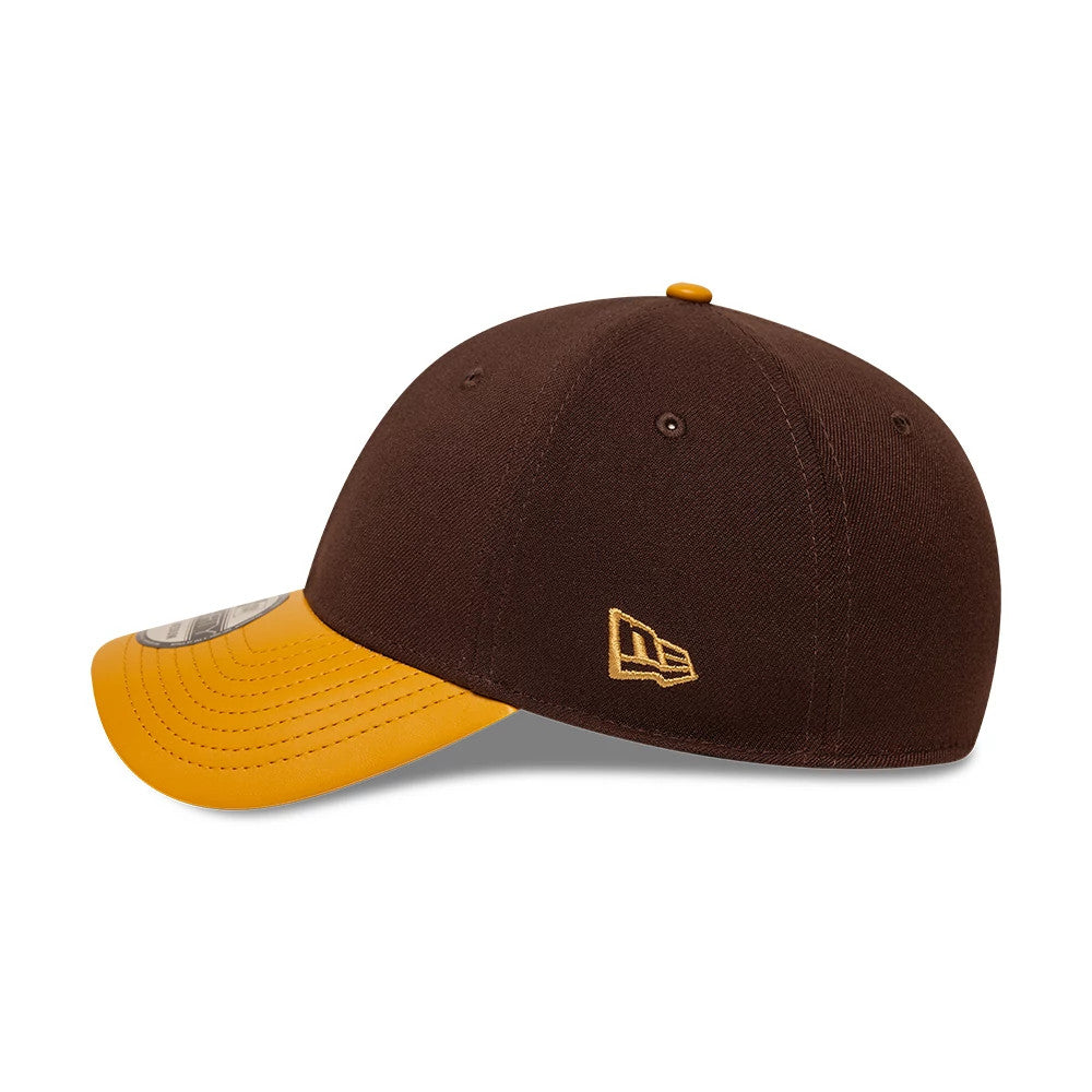 New Era Dark Brown 39THIRTY Stretch Fit Cap, side view showing the gold embroidered New Era flag logo on the left side of the structured dark brown crown, paired with a curved yellow visor and a matching top button.
