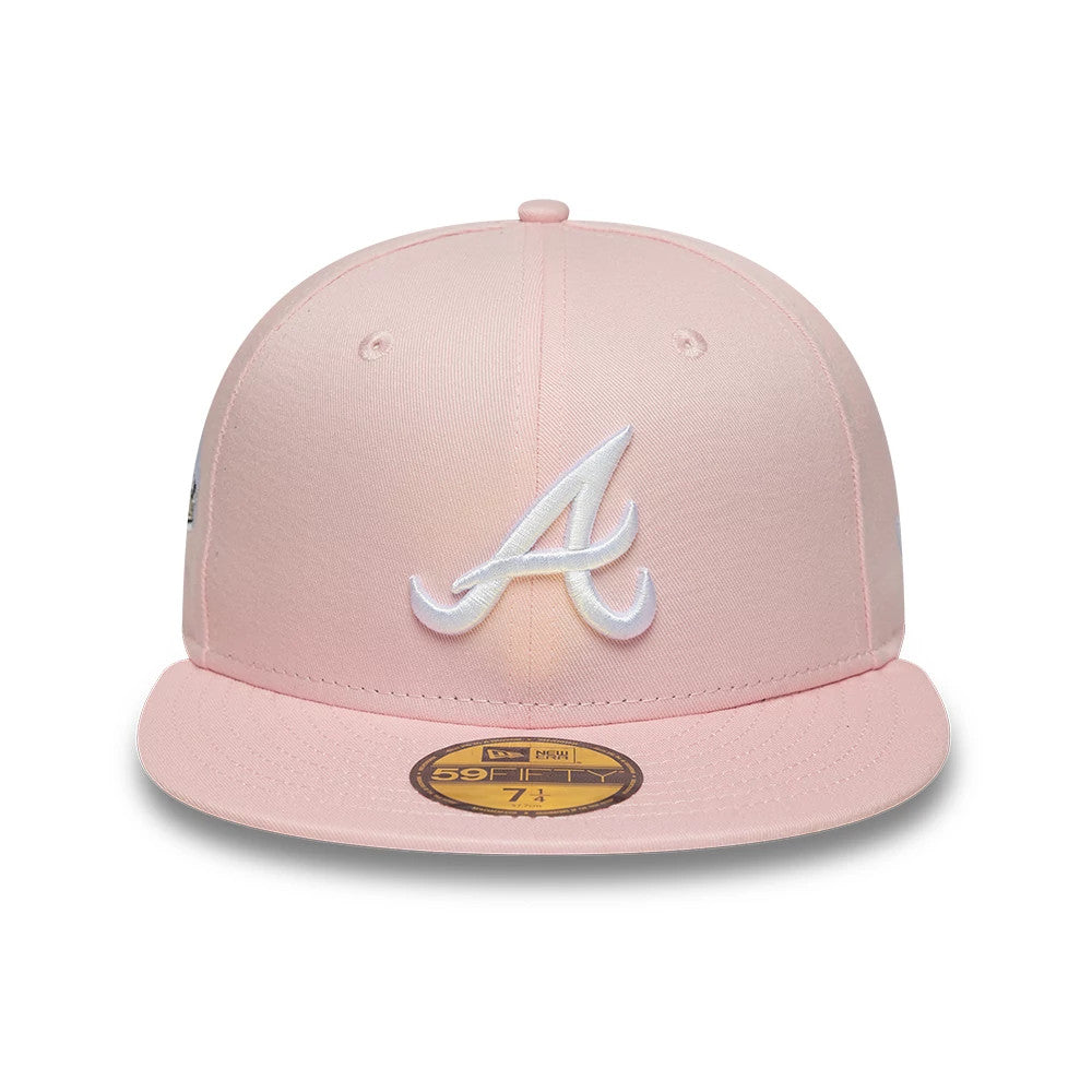 Atlanta Braves MLB Pink New Era 59FIFTY Fitted Cap, front view showing the white embroidered Atlanta Braves logo on the structured pink crown, with a flat pink visor and a gold 59FIFTY size sticker displayed on the top.