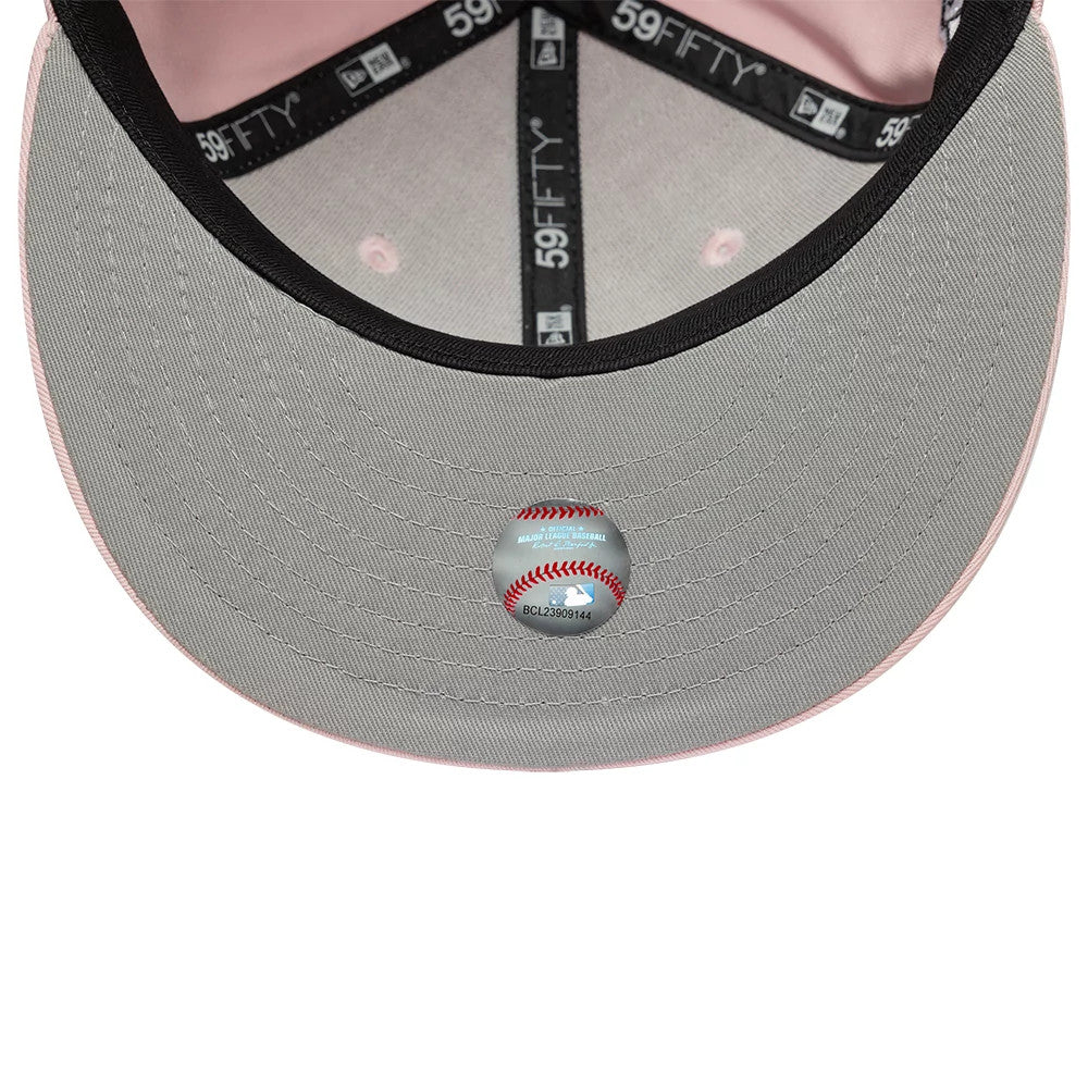 Atlanta Braves MLB Pink New Era 59FIFTY Fitted Cap, inside view showing grey undervisor with an MLB baseball-shaped holographic sticker, black 59FIFTY branded taping, and a pink sweatband lining the interior.