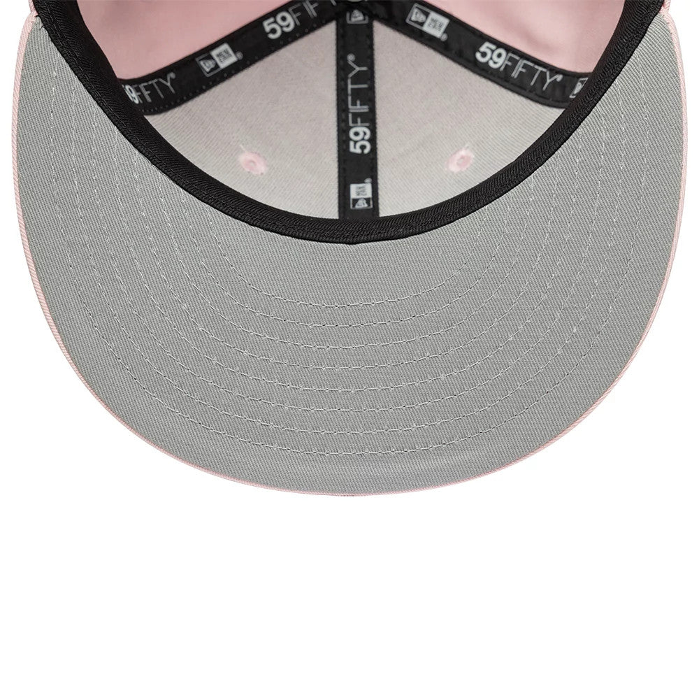 New Era Heritage Connect Pastel Pink 59FIFTY Fitted Cap, inside view showing the light grey undervisor with neat stitching, black New Era branded taping along the interior seams, and a pastel pink lining on the inner panels.