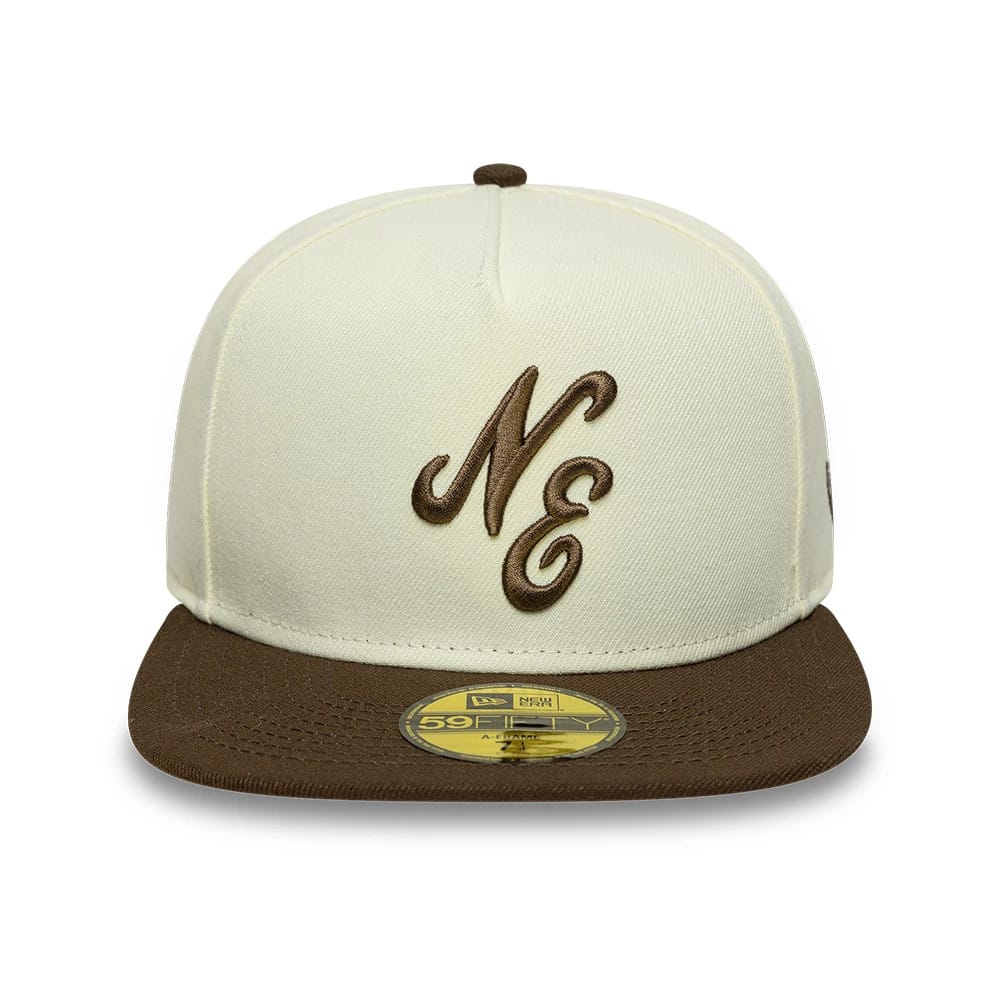 New Era Cream 59FIFTY A-Frame Fitted Cap, front view showing brown embroidered NE lettering on the structured cream crown, brown flat visor, and a gold 59FIFTY size sticker placed centrally on the visor.