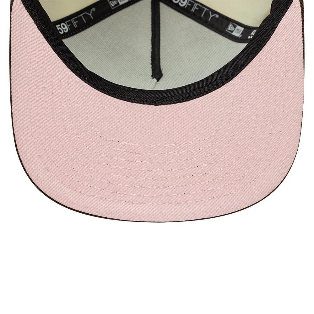 New Era Cream 59FIFTY A-Frame Fitted Cap, inside view showing a light pink undervisor with black trim detail at the edge, black 59FIFTY branded taping along the inner seams, and a beige sweatband providing contrast.