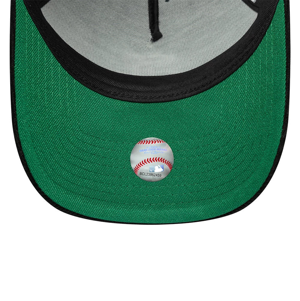 Chicago White Sox MLB Cord Black New Era 9FORTY A-Frame Adjustable Cap, inside view showing the grey taping along the seams, the dark green undervisor and a red baseball sticker placed centrally near the edge of the black sweatband.