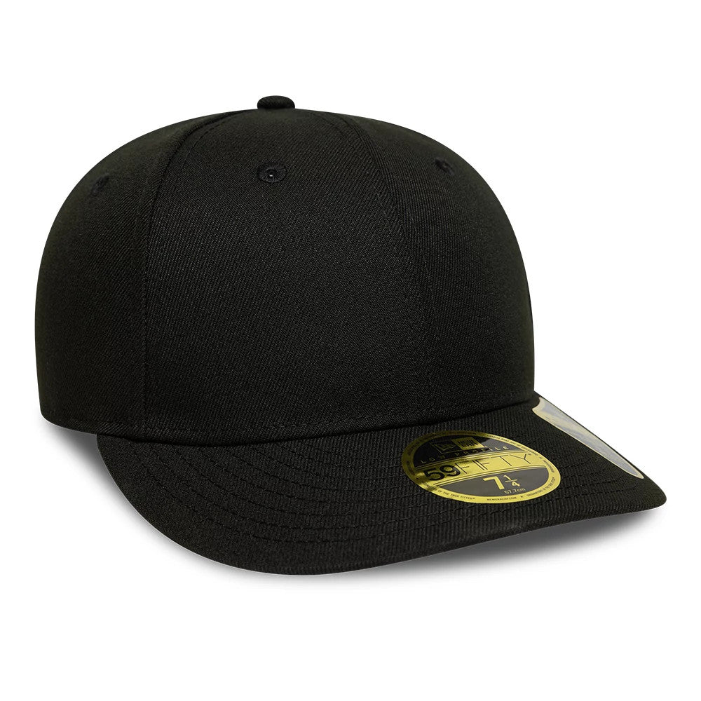 New Era Black Low Profile 59FIFTY Fitted Cap, three-quarter view showing the curved black visor with a gold 59FIFTY size sticker, a structured low-profile crown with embroidered eyelets, and a matching black top button.