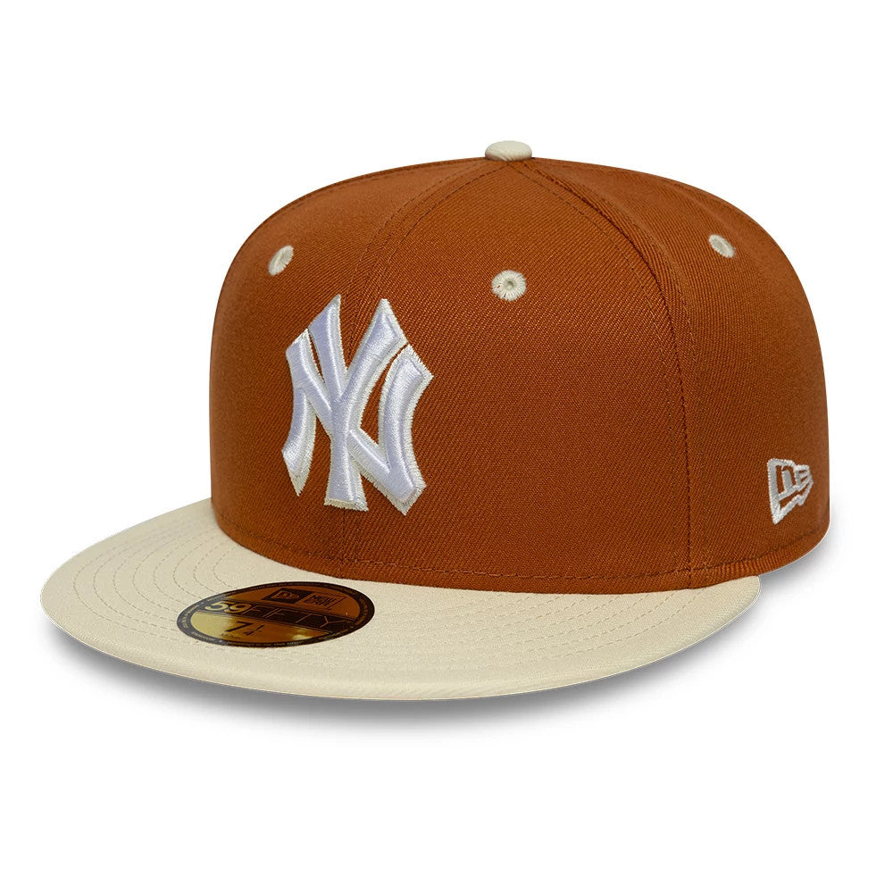New York Yankees MLB Contrast Brown New Era 59FIFTY Fitted Cap, three-quarter view showing the white raised embroidered Yankees logo on the front panel, a cream visor with a gold 59FIFTY size sticker, and the New Era flag logo on the left side.